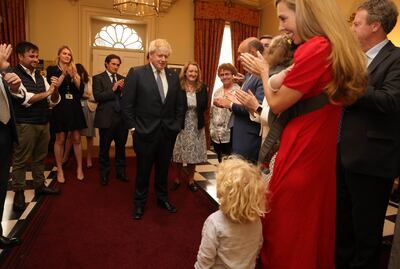 Boris Johnson is applauded by his wife Carrie, son Wilfred and staff after announcing his resignation in July. Photo: 10 Downing Street
