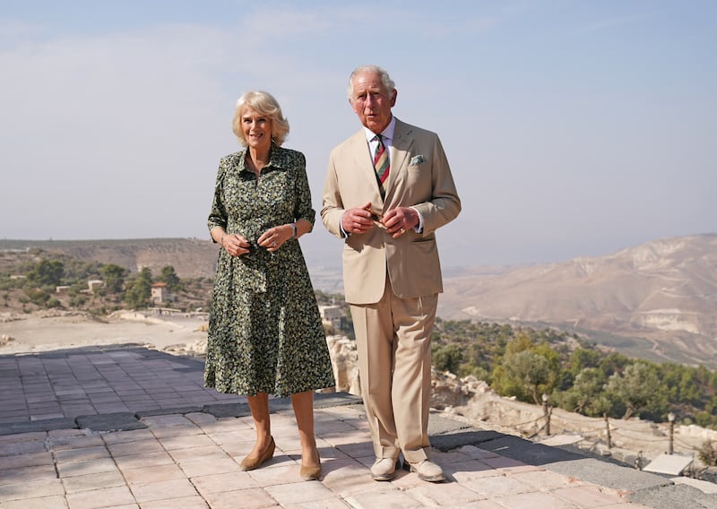Prince Charles and Camilla, Duchess of Cornwall, wearing a black and khaki Fiona Clare dress, take a walking tour of Umm Qais in Jordan. Getty Images