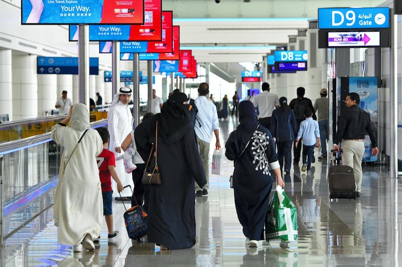 A picture take on September 14, 2017 shows people walking at Dubai's International Airport . / AFP PHOTO / GIUSEPPE CACACE