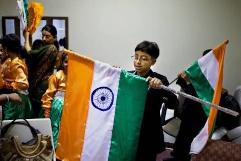 Ten-year-old Alan Abraha carefully rolls up the Indian flag after his performance as he and members of the Indian community gather to celebrate the 65th Independence Day of India on Monday morning, August 15, 2011, at the Embassy of India in Abu Dhabi. The function was commenced with the hoisting of the Indian flag and followed by reading of the "President's Address to the Nation" by his Excellency Mr. M.K.Lokesh, Ambassador of India to the UAE. Children from the local Indian schools then sang patriotic songs and danced. (Silvia Razgova/The National)

