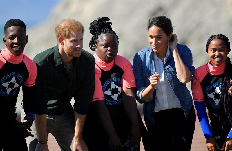 The Duke and Duchess of Sussex, Prince Harry and his wife Meghan, meet with members of the NGO Waves for Change, during their African tour, on Monwabisi Beach in Cape Town, South Africa. REUTERS