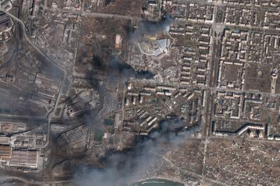 A satellite photo from Planet Labs shows civilian buildings burning after Russian strikes on Mariupol. AP 