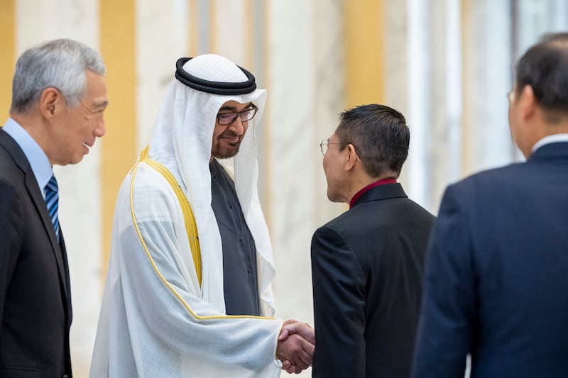 President Sheikh Mohamed greets a dignitary accompanying Mr Lee during an official reception at Qasr Al Watan. Ryan Carter / UAE Presidential Court
