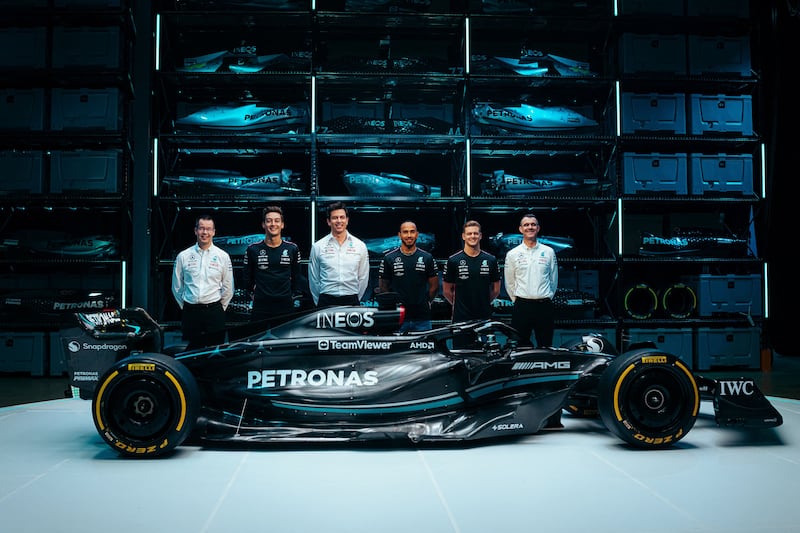 Mercedes' George Russell, team principal Toto Wolff, Lewis Hamilton and reserve driver Mick Schumacher with the new W14 E car for the 2023 season in Silverstone. AFP