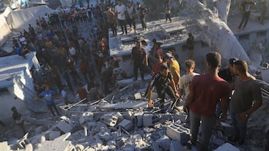 Palestinians search for bodies and survivors in the rubble of a residential building destroyed in an Israeli air strike in Khan Younis, Gaza Strip. AP