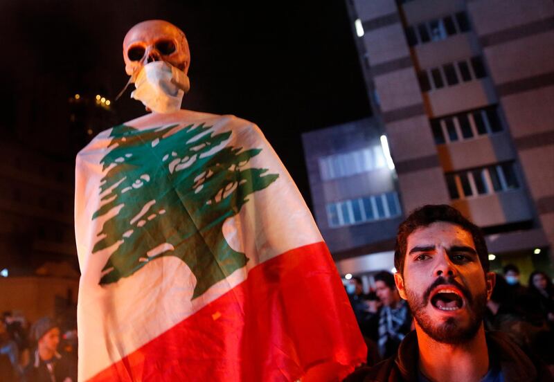 A protester shouts slogans during ongoing protests against the country's financial woes in Beirut. AP Photo