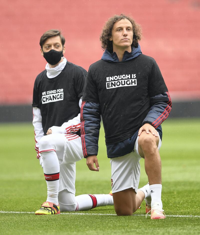 LONDON, ENGLAND - JUNE 10: Mesut Ozil and David Luiz of Arsenal take a knee in support of Black Lives Matter before the friendly match between Arsenal and Brentford at Emirates Stadium on June 10, 2020 in London, England. (Photo by David Price/Arsenal FC via Getty Images)