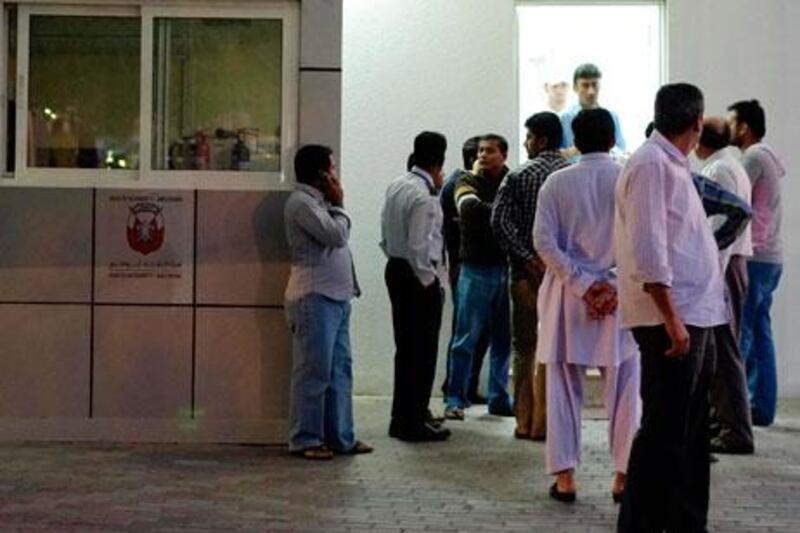 AL AIN, UNITED ARAB EMIRATES,  February 04, 2013. Friends, family and co-workers wait outside the Al Ain Morgue, at the Al Ain Hospital, for news about the deceased in todays accident where a construction truck filled with sand capsized on a bus filled with labourers. (ANTONIE ROBERTSON / The National)