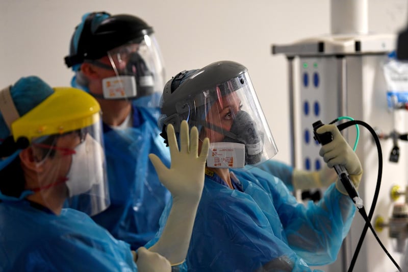 Clinical staff wear personal protective equipment (PPE) while caring for a patient in the Bronchoscopy unit at the Royal Papworth Hospital, operated by the Royal Papworth Hospital NHS Foundation Trust, in Cambridge, U.K., on Tuesday, May 5, 2020. The U.K.'s coronavirus death toll soared passed that of Italy, making it the worst hit country in Europe, as a top British official expressed regret over the lack of testing in the early stages of the outbreak. Photographer: Neil Hall/EPA/Bloomberg