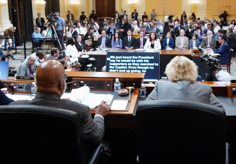 Committee members listen as Ms Hutchinson speaks during the hearing. Pool via Reuters