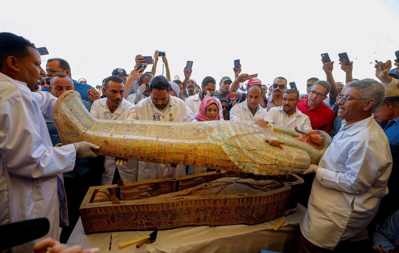 Archaeologists remove the cover of an ancient painted coffin discovered at Al-Asasif Necropolis in the Vally of Kings in Luxor, Egypt. Reuters