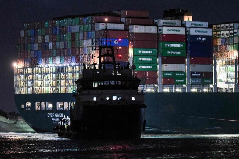 A tugboat by the Panama-flagged MV Ever Given container ship. AFP
