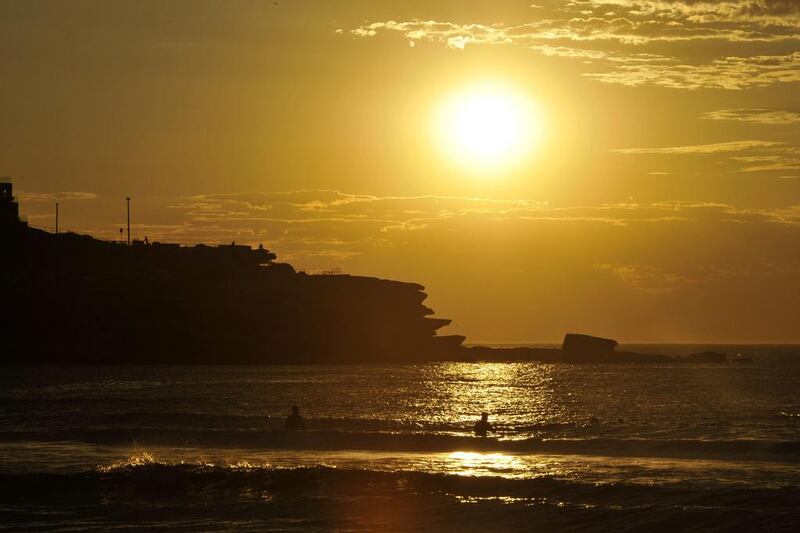 epa05725519 People go for an early morning surf at sunrise at Bondi Beach in Sydney, Australia. Joel Carrett / EPA