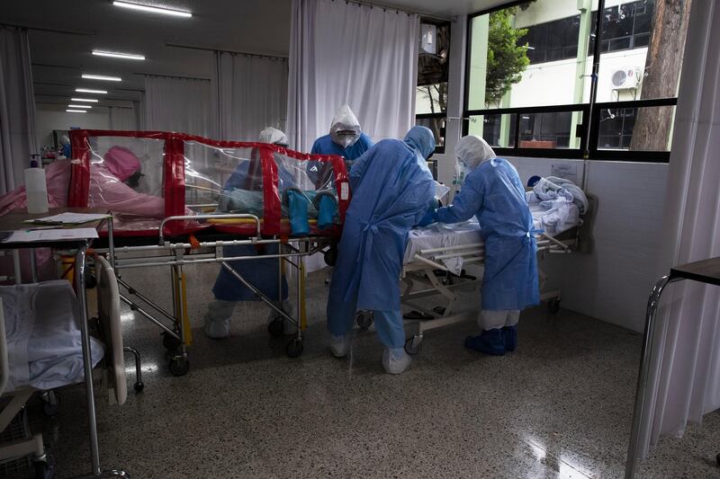 Military surgeon, Coronel Oscar Benavides Aguilar and his team place a Covid-19 patient in an isolation chamber before moving him to an X-Ray room at a military hospital in Mexico City. AP Photo