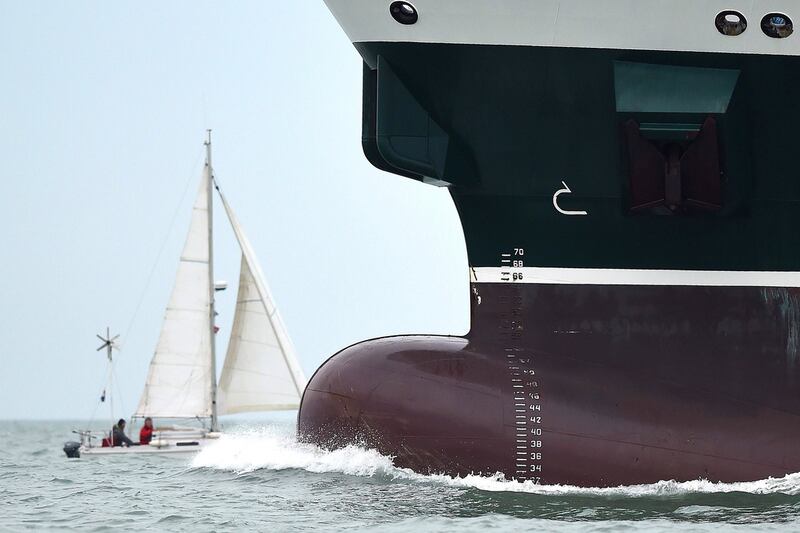 A picture taken on March 3, 2017 in Les Sables-d’Olonne, western France shows a tanker and a yacht sailing during the arrival of Dutch skipper Pieter Heerema, who placed 17th in the Vendee Globe around-the-world solo sailing race. Jean-Sebastien Evrard / Agence France-Presse