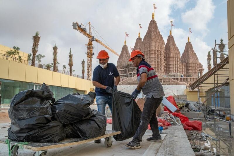 Worshippers help clean up the area surrounding the Hindu temple. Photo: BAPS Hindu Mandir