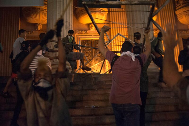 Protesters try to invade the state assembly during a protest in Rio de Janeiro, Brazil, Monday, June 17, 2013. Officers in Rio fired tear gas and rubber bullets when a group of protesters invaded the state legislative assembly and threw rocks and flares at police. Protesters massed in at least seven Brazilian cities Monday for another round of demonstrations voicing disgruntlement about life in the country, raising questions about security during big events like the current Confederations Cup and a papal visit next month. (AP Photo/Nicolas Tanner) *** Local Caption ***  Brazil Protests.JPEG-080e7.jpg