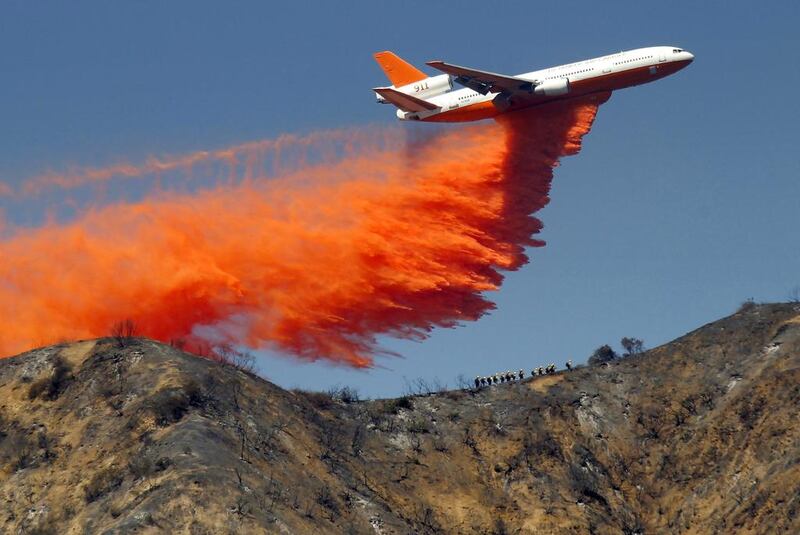 A Douglas DC10 tanker drops fire retardant on a wildfire in the San Gabriel Mountains in Azusa, California. Nick Ut / AP Photo