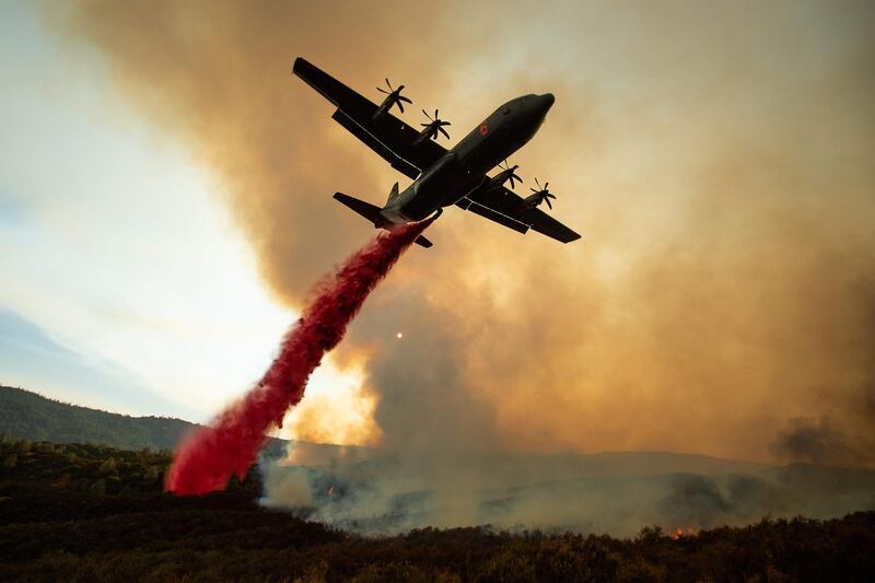 An air tanker drops retardant on the Ranch Fire, part of the Mendocino Complex Fire, burning along High Valley Rd near Clearlake Oaks, California. Noah Berger/AFP