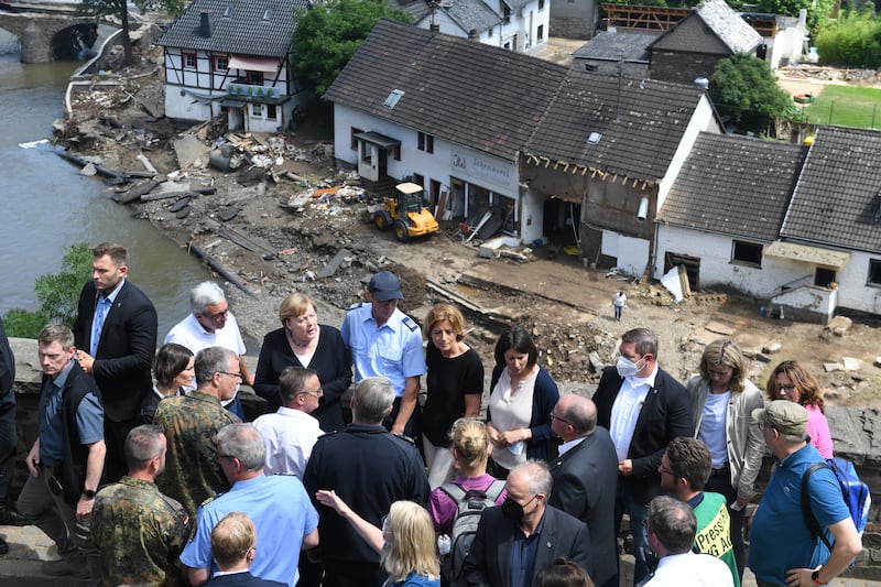Mrs Merkel visiting flood-ravaged areas to survey the damage and meet survivors in July 2021, in Schuld, near Bad Neuenahr-Ahrweiler. Getty Images