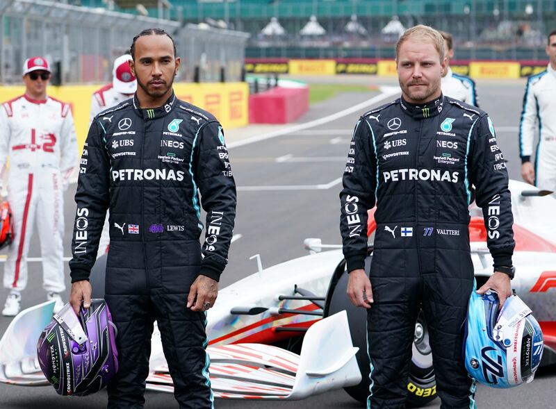 Mercedes drivers Lewis Hamilton and Valtteri Bottas with a model of the 2022 F1 car revealed at Silverstone.