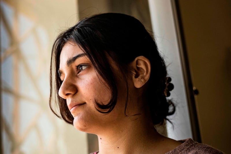 Layla Eido, a teenager from Iraq's minority Yazidi community, is pictured in the countryside of Syria's northeastern province of Hasakeh on April 23, 2020. Years after jihadists stole her away to Syria, Eido finally recontacted her family in Iraq several months ago. But a coronavirus lockdown has delayed their long-awaited reunion. She has been stuck in northeast Syria since the Islamic State group's so-called "caliphate" collapsed last year, ending her jihadist captivity. But just when she was on the cusp of reuniting with her family, the novel coronavirus pandemic forced both Iraq and Syria to close their borders, stalling her return.
 / AFP / DELIL SOULEIMAN
