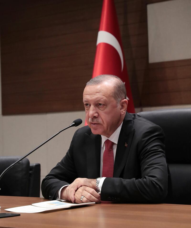 Turkey's President Recep Tayyip Erdogan speaks to the media before his departure for Argentina to attend G-20 meetings, at Ataturk airport in Istanbul. AP