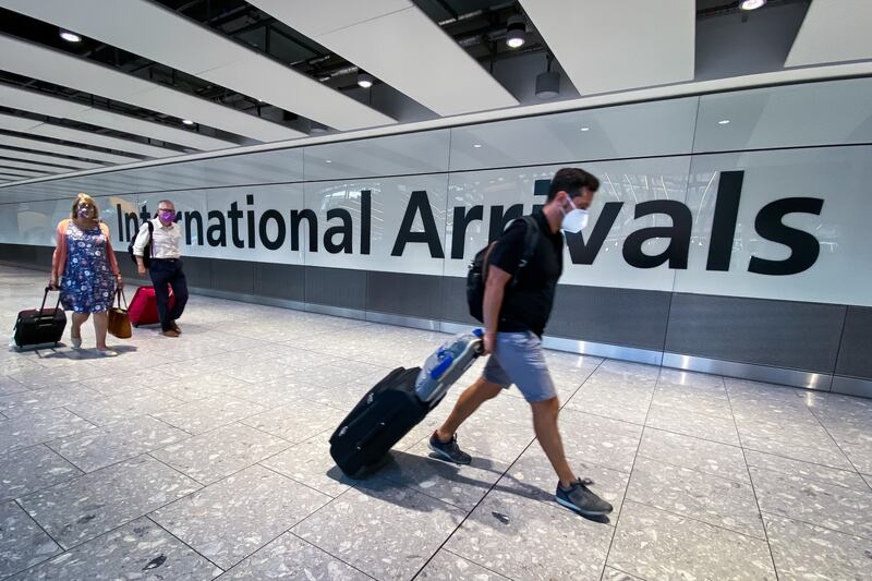 Passengers arrive at Heathrow Airport, London, December 5, 2021.