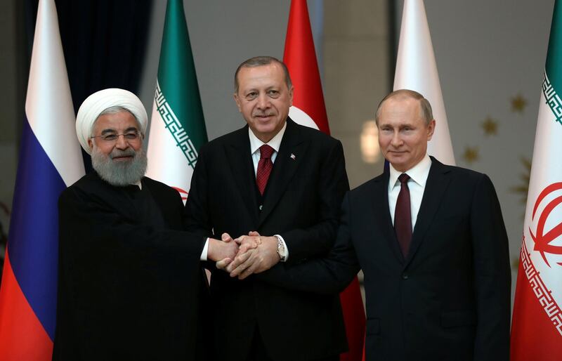 Presidents Hassan Rouhani of Iran, Tayyip Erdogan of Turkey and Vladimir Putin of Russia pose before their meeting in Ankara, Turkey April 4, 2018. Tolga Bozoglu/Pool via Reuters