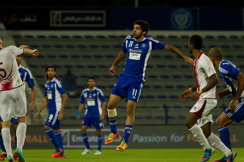 Dubai, United Arab Emirates - November 18 2012 -  Hassan Mohamed jumps to gain hold of the ball during the second half of a match.  Al Nasr beat Al Wahda 4-1 at Al Nasr Stadium on Sunday night. (Razan Alzayani / The National)