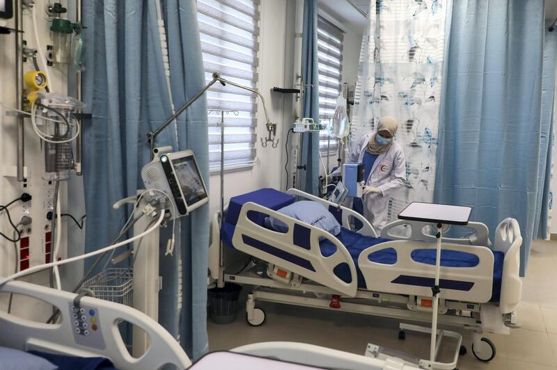 Palestinian medical staff are pictured in the newly opened Red Crescent Hospital dedicated to coronavirus, in the occupied-West Bank city of Nablus on January 16, 2021. - The Palestinian health ministry has recorded more than 102,000 cases coronavirus cases in the West Bank, including 1,164 deaths. (Photo by JAAFAR ASHTIYEH / AFP)