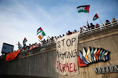 Protesters wave Palestinian flags, chant slogans and hold banners during a Pro-Palestinian demonstration on Waterloo Bridge in London. AFP