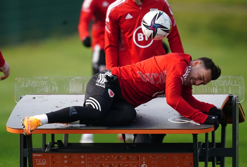 Wales player Connor Roberts playing Teqball with team-mates during training. PA