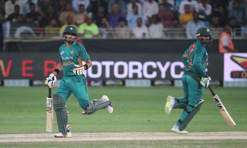 Pakistan cricketer  Babar Azam (L) and Asif Ali (R) play a shot during T20 cricket match between Pakistan and New Zealand at the Dubai Cricket Stadium in Dubai on November 2, 2018 / AFP / KARIM SAHIB
