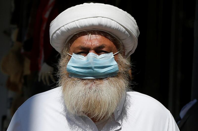 A man wears a protective face mask as he walks along the main market in downtown after the government eased the restrictions on movement aimed at containing the spread of the coronavirus, in Amman, Jordan. Reuters