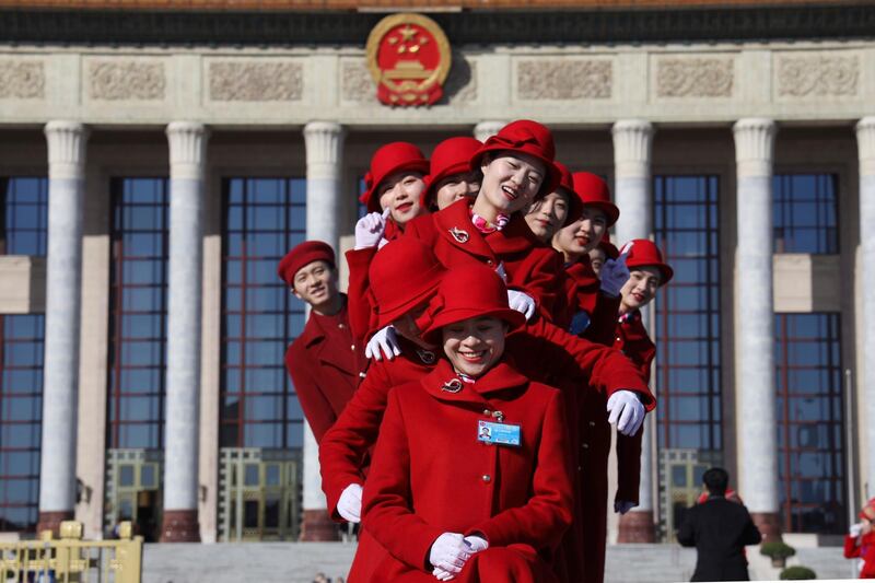 Chinese bus ushers pose for photos outside the Great Hall of the People during a plenary session of the National People's Congress held in Beijing, China. AP Photo