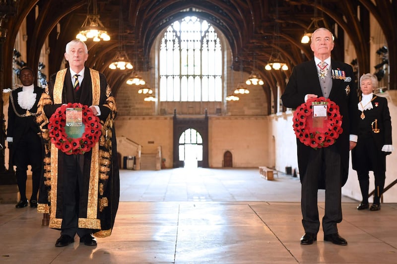 Speaker of the House of Commons Lindsey Hoyle, left, attends a wreath-laying service in the Houses of Parliament to coincide with the 11:00 am nationwide two-minute silence. AFP