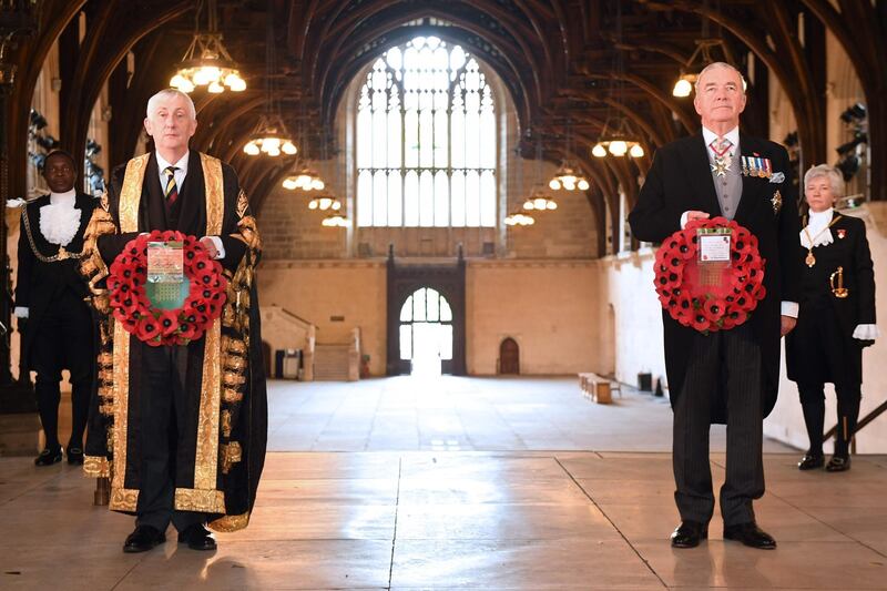 Speaker of the House of Commons Lindsey Hoyle, left, attends a wreath-laying service in the Houses of Parliament to coincide with the 11:00 am nationwide two-minute silence. AFP