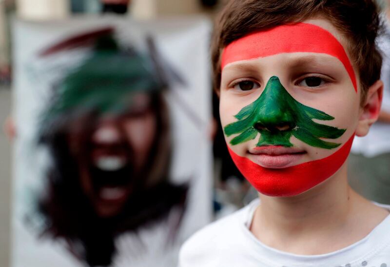 A Lebanese boy with a national flag painted on his face takes part in an anti-government demonstration in the capital Beirut's downtown district. AFP