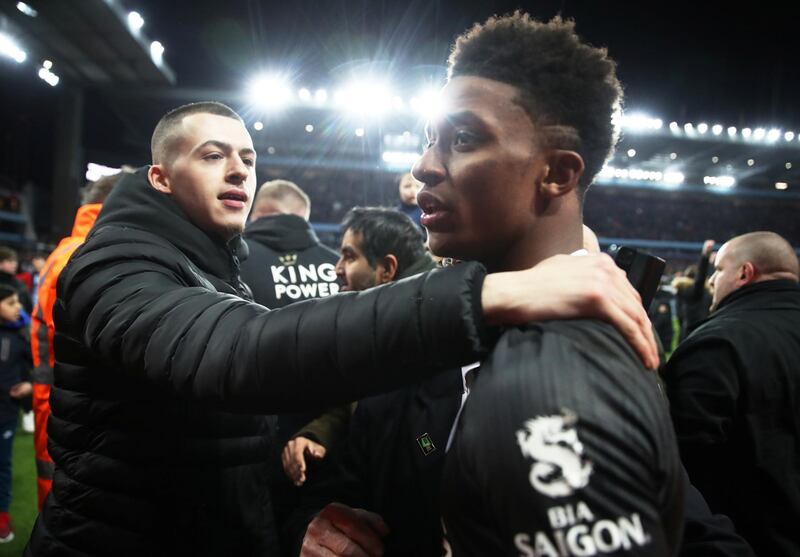 Leicester City's Demarai Gray is consoled by a supporter at the end of the match. Reuters