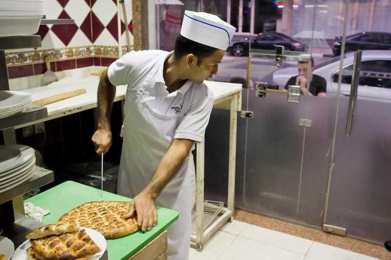 DUBAI, UNITED ARAB EMIRATES,  JULY 18, 2013. Anowar Hussein a cook at Harput Turkish restaurant in Al Barsha prepares food for hungry Iftar goers while him and the rest of the kitchen will wait till after the Iftar rush to have their own meal.  (ANTONIE ROBERTSON / The National) No Journalist *** Local Caption ***  AR_1807_Iftar_Cooks-1.jpg