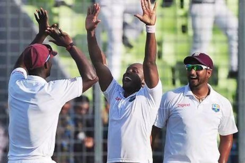 Tino Best, centre, celebrates with his West Indies teammates after the visitors bowled out Bangladesh for 167 in their second innings. Munir uz Zaman / AFP