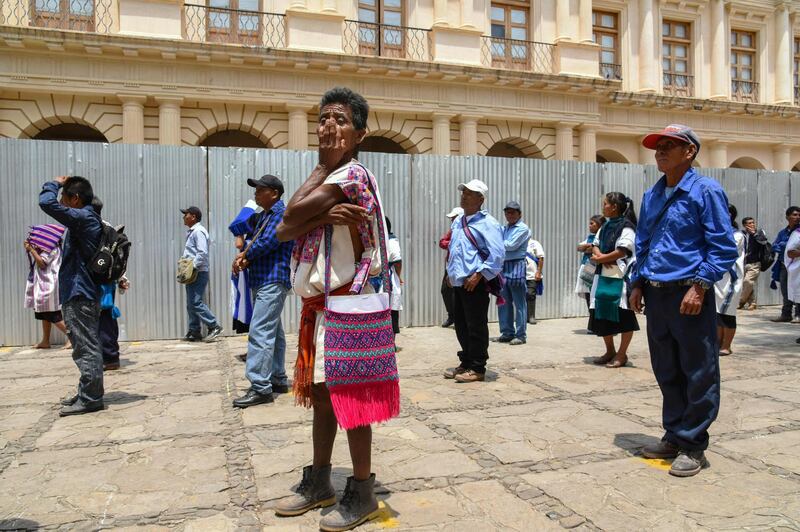 Indigenous people from the Altos de Chiapas queue -keeping social distancing- while waiting for an allowance from the local government in Chiapas, Mexico.  AFP