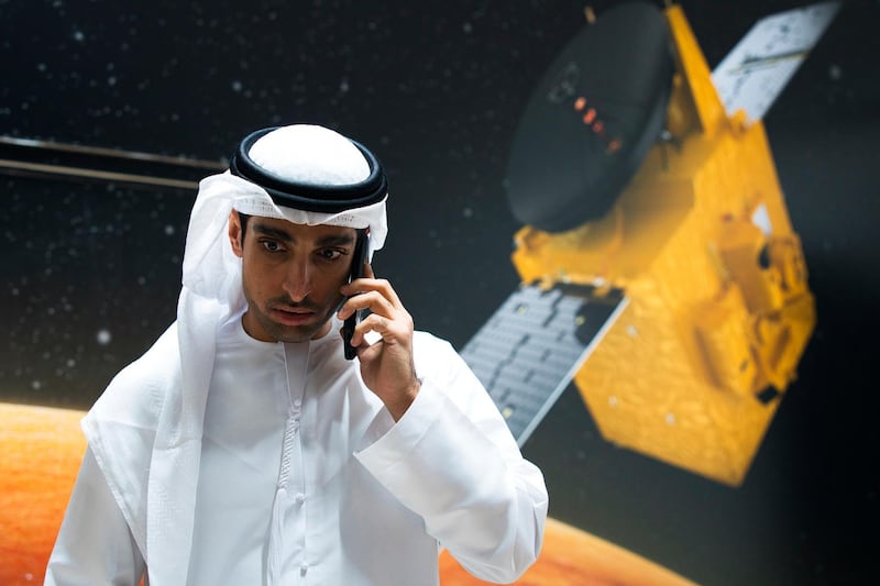 Omran Sharaf, the project director for the Emirates' Hope space probe to Mars, speaks on his mobile phone at the Mohammed bin Rashid Space Center in Dubai, United Arab Emirates, Sunday, July 19, 2020. A Japanese H-IIA rocket carrying a United Arab Emirates Mars spacecraft has been placed on the launch pad for Monday's scheduled liftoff for the Arab world's first interplanetary mission, officials said Sunday. (AP Photo/Jon Gambrell)