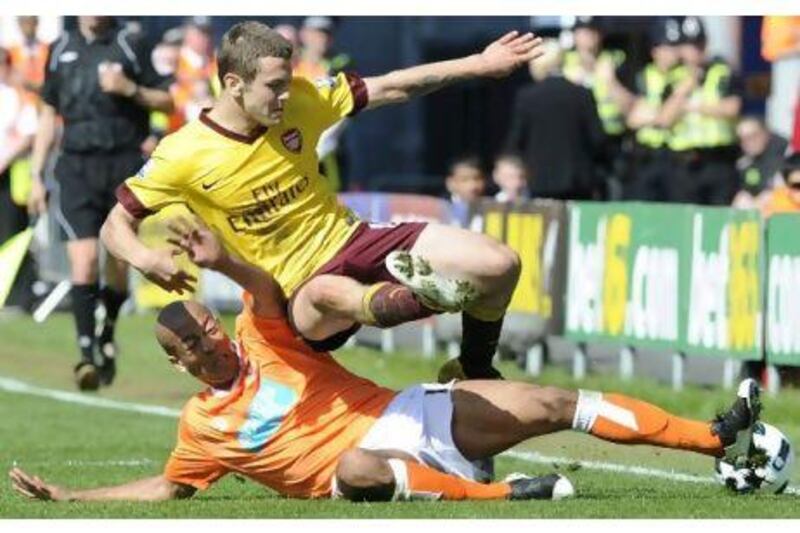 Blackpool's Alex Baptiste challenges Arsenal's Jack Wilshere during a 3-1 defeat at Bloomfield Road yesterday.