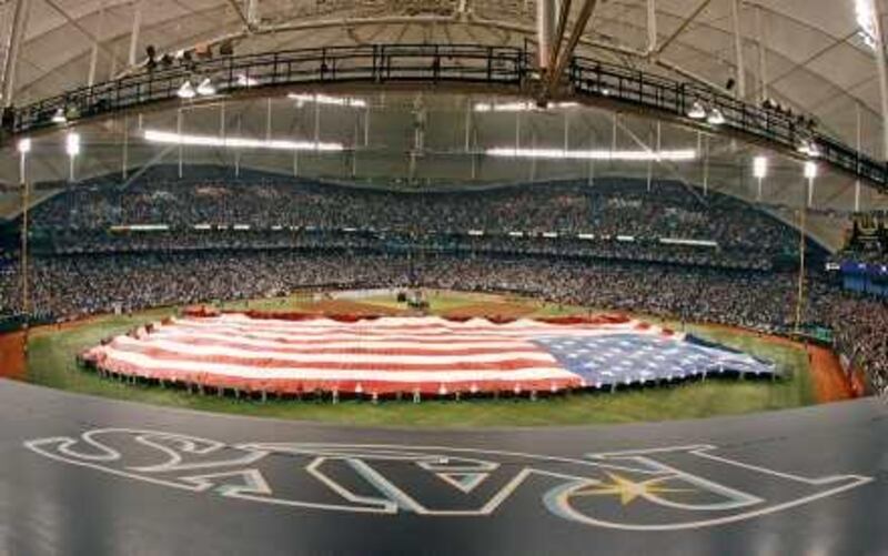 A large American flag is unfurled across the outfield at Tropicana Field in St. Petersburg, Fla. before Game 1 of the baseball World Series, Wednesday, Oct. 22, 2008. (AP Photo/Mike Carlson)  *** Local Caption ***  WS301_World_Series_Phillies_Rays_Baseball.jpg