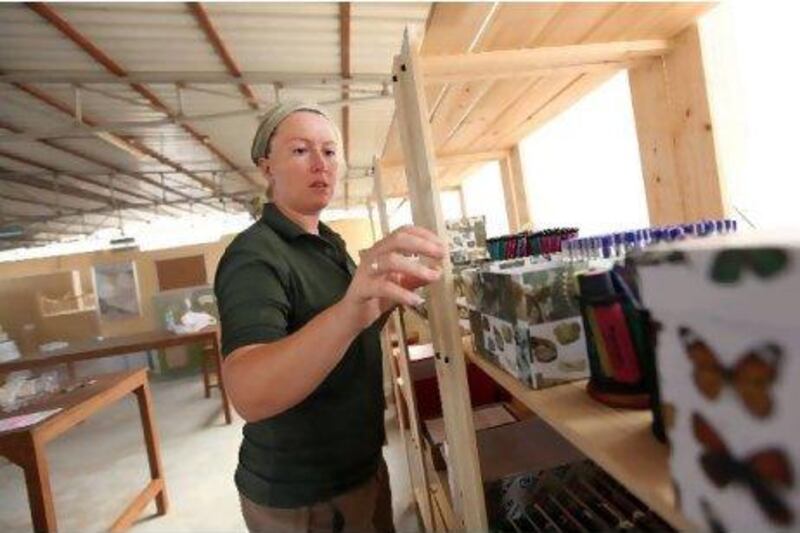 Emma Smart sets up supplies at the Ecoventure centre in preparation for its grand opening.