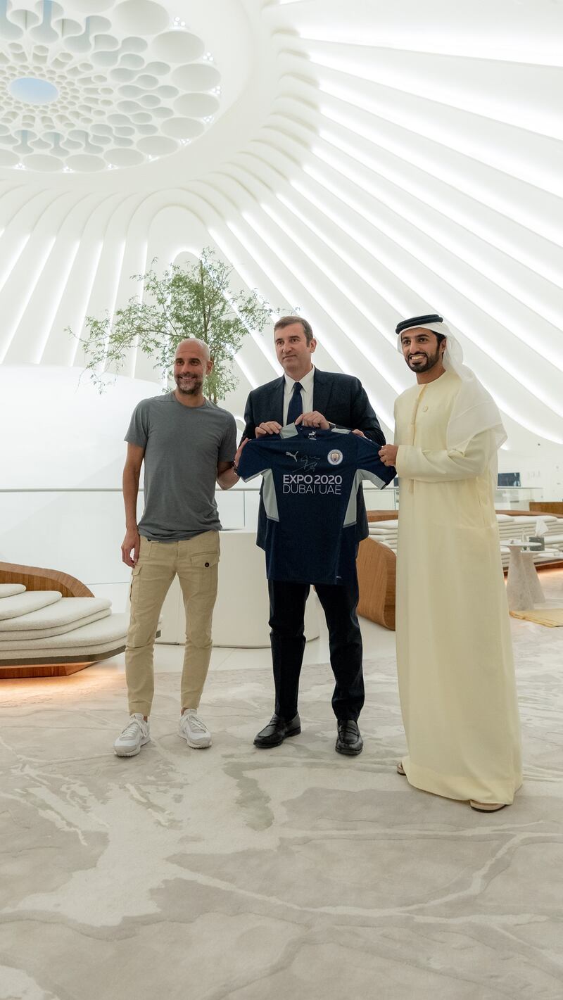 Left to right: Manchester City manager Pep Guardiola, left, and chief executive Ferran Soriano, are presented with an Expo 2020 Dubai shirt by Sheikh Rashid bin Humaid Al Nuaimi, president of the UAE Football Association. Photo: UAE FA
