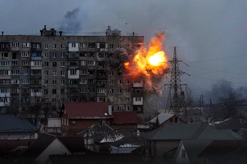 An explosion is seen in an apartment building after a Russian army tank fires in Mariupol. AP Photo