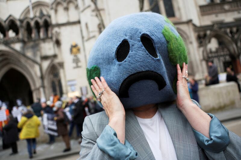 A climate activist demonstrates outside the Royal Courts of Justice in London. Reuters